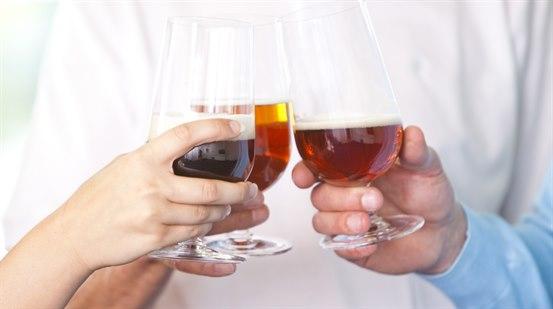 Illustrasjonsfotoet viser nærbilde av tre glass med alkohol som det skåles med