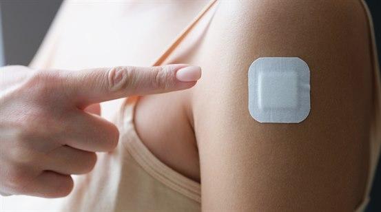 Utsnitt av kvinnes overarm med østrogenpaster (?) på overarrm